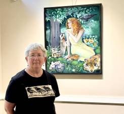 Shelly Meisler poses in front of one of her works.