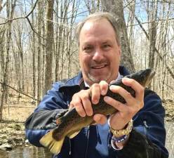 DA Hoovler helps the Orange County Federation of Sportsmen stock trout.