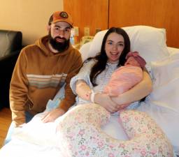 Abigail and Cory Nicholson hold their newborn Cali Quinn.