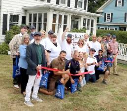 On Wednesday, Aug. 18, Town of Warwick Supervisor Michael Sweeton (right), Mayor Michael Newhard (left) and members of the Warwick Valley Chamber of Commerce joined owners Eileen and Jim Patterson (standing center), their family, staff, clients and business associates to celebrate five years of Track 7 new management with a ribbon-cutting ceremony. Photo by Roger Gavan.