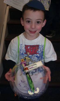 Evan Leeds, 5, of Monroe displays the clown-themed Purim &#147;gragger&#148; (noisemaker) he designed.