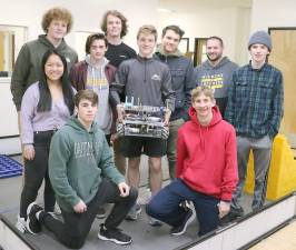 Some of the members of the Warwick Valley High School’s winning robotics team pose with advisor Michael Stolt and their robot “Sheila.”