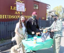 On Saturday, April 24, volunteers were invited to stop by the table near the chamber’s South Street Caboose office to pick up free rubber gloves, garbage bags and refreshments. From left, Elizabeth Verboys, a member of Girl Scout Cadet Troop 733, and Warwick Valley Chamber of Commerce Executive Director Michael Johndrow hand over a few supplies to an Operation Clean Sweep volunteer, Town of Warwick Supervisor Michael Sweeton. Photos ny Roger Gavan.