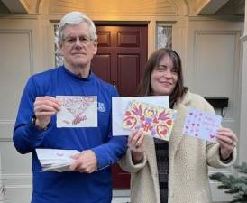 Meals on Wheels volunteer Bill Lindberg and Mary Collura from Warwick Cares display handcrafted Valentine’s Day cards.