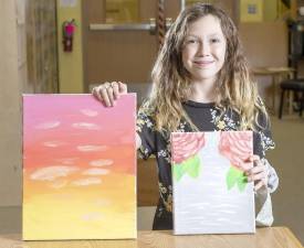 Superintendent's Artist of the Week Emma Fontaine with two of her paintings at Sanfordville Elementary School. Photo by Tom Bushey/Warwick Valley School District.