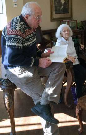 Mitzi Gerris listens while her brother Mickey Corn reads an excerpt from the book she began writing 55 years.