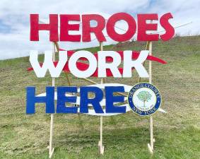 Members of the Bruderhof community unveiled a giant sign located at the crossroads of the Orange County Sheriff’s Office and the Emergency Services Center as symbol of recognition for all essential workers who are working during this extraordinary crisis.