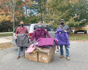 Michael Peters (left), Resource Exchange Coordinator for Catholic Charities of Orange, Sullivan and Ulster, accepted a donation of 48 new winter coats for children from the Warwick Valley Knights of Columbus. Council members Jack Ellis (center) and Bob Long (right) presented the donation to Peters. Photo provided by Kristin Jensen.