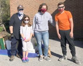 From left volunteer Carmine LaMattina, student MaryGrace Gargiulo, 8, Principal Bethany Negersmith and volunteer Phillip Gargiulo.