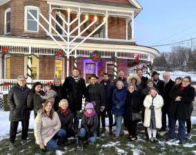 The Temple Beth Shalom congregation celebrates the lighting of Menorah with Rabbi Borenstein, Florida Mayor Daniel Harter, Jr. and trustees.