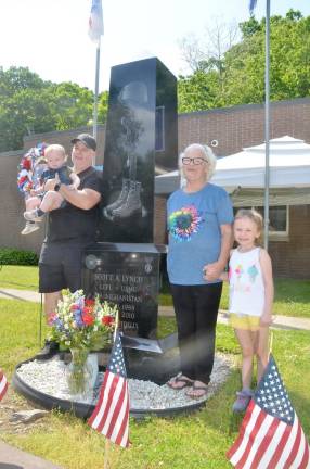 Standing by the memorial for Scott Lynch, who was killed in Afghanistan: Jerry Lynch, brother to Scott,, holds Sebastian, Scott’s cousin. On the other side of the memorial, Patricia Williams, Scott’s aunt, and Kylie, Scott’s cousin.