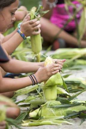 Photos by Tom Nycz Photography A corn shucking contest.