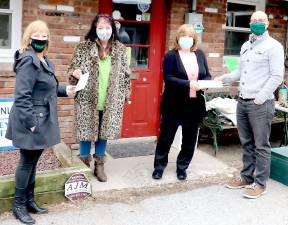 Green Team New York Realty presents donations to Warwick Valley Humane Society and Warwick Area Migrant Committee, two non-profit organizations selected by its “Citizen of the Year” Carol Buchanan. From left, Carol Buchanan, Suzyn Barron, Kathy Brieger and Geoff Green. Photo by Roger Gavan.