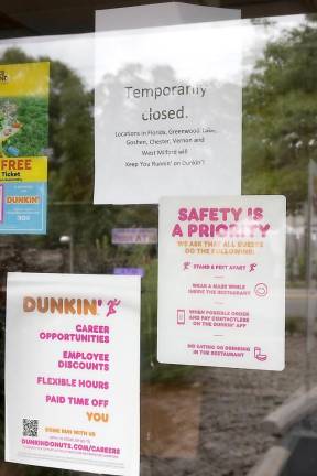 These are the signs that greeted customers last week at Warwick Dunkin’ Donuts on Main Street. Photo by Robert G. Breese.