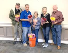 Warwick Rotarians Chris Olert and Stan Martin, left, deliver long-stemmed roses to Liberty Green senior residents Wanda McDowell, Nancy Brandt and Mike DiCaprio.