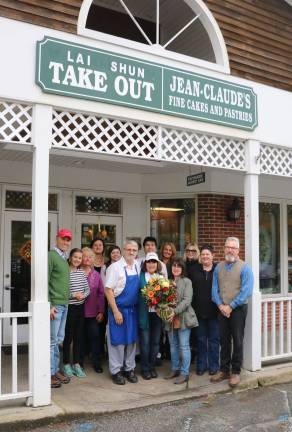 Photo by Roger Gavan On Sunday, Oct. 28, Mayor Michael Newhard (far right) and Merchant Guild past President Mary Beth Schlichting (center front right), along with a group of merchants and loyal customers, arrived at Jean Claude's Artesian Bakery and Dessert Caf&#xe9; in the Village of Warwick to express their appreciation for one of the village&#x2019;s most cherished businesses. On behalf of her fellow merchants, Schlichting presented a bouquet of flowers to Jean Claude and Annette Sanchez (center) and, after posing for photos, the group returned to the caf&#xe9; for a Champagne toast.