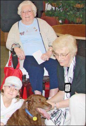 Therapy dog listens to Sweet Adelines sing, then goes to work