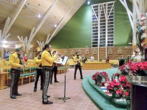 During the mass the Mariachi band, “Viva Mexico,” served as the choir singing liturgical songs in Spanish. And afterwards, they sang renditions of traditional Mexican songs before a statue of Our Lady of Guadalupe by the altar.
