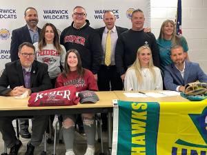 Warwick Wildcats take a quick mask break for a picture to celebrate the Division I signings of National Letters of Intent for Samantha Killin (Rider) and Grace Hennessey (UNC Wilmington). Superintendent of Schools Dr. David Leach and Athletic Directory Gregory Sirico join the families in celebrating. Photo provided by Warwick Valley School District.