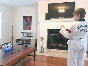 Black Belt Leonardo Blic, a student of the Chosun Taekwondo Academy, practices at home via live-stream classes.