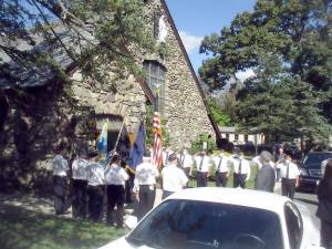 On October 3rd a memorial service was held at Holy Rosary Church in Greenwood Lake, NY for William (Bill) J Kraham. Service was officiated by Legion Chaplain Father Robert Sweeney. Bill was 77 years old from from Warwick, and formerly of Greenwood Lake. He was a member of Greenwood Lake Post 1443 Arthur Finnegan American Legion Post. The Legion formed a color guard with members standing on the sidewalk of the entrance to the church. The service ended outside on the street with a bagpiper playing and a bugle player playing “Taps.” The American flag was folded in front of the Legion color guard and presented to his widow Barbara. After the funeral a luncheon was held at the American Legion. Photo by Ed Bailey.