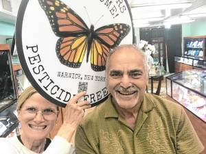 Sally Greco holds one of her signs with Moshe Schwartzberg of Forever Jewelers. Schwartzberg’s daughter purchased two of the signs for him as a Father’s Day present.