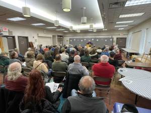 Prof. Richard Hull addresses a standing room-only crowd at the Greenwood Lake Library.