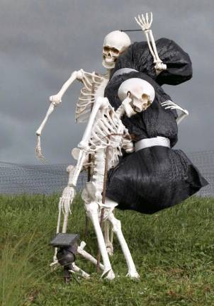 The bone white of these skeletons carrying what appears to be a wrapped up body stood out against the dark gloomy skies of Saturdays late afternoon storm at West St and Eagles Watch Rd in Warwick.