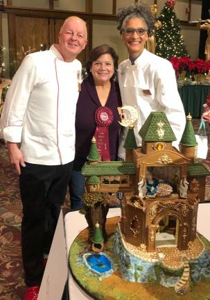 Provided photos Vanessa Greeley is flanked by two judges from the Food Network - Carla Hall from The Chew, and Chef Nicolas Lodge, the head judge for the gingerbread contest.