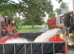 Past Chief William DiMartini of the Raymond Hose Company #2 drops tank water into a portable pool for operations for firefighters. Photos provided by Warwick Fire Department.