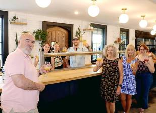 Gathered around the bar with Drowned Lands Brewery staff (rear from left) Emily Cavanagh, Shannon Willis and business owner Mike Kraai, are (front from left): Warwick Valley Chamber of Commerce Programs Committee Member John Redman, Chamber Business Manager Karen Wintrow, Programs Chair Janine Dethmers and Public Relations Coordinator Olivia DiCostanzo. Photo by Roger Gavan.