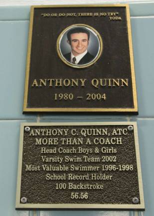 A plaque memorializing Anthony Quinn, an accomplished Warwick Valley swimmer, hangs on the tile wall overlooking the WVHS Anthony C. Quinn Memorial Swimming Pool.