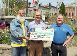 On Friday, May 7, Warwick Valley Rotary Club President Edward Lynch (right) and Rotary member Wayne Patterson (left) presented a check for $500 to Geoffrey Green, founder of Green Team Realty and Team Up for Hope. Photo by Roger Gavan.