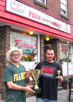 Matt Rinaldi, owner of Frank's Pizza, presented a gift certificate and the smaller trophy to first-time winner Christopher McGann. His name will be engraved along with prior winners on the larger trophy displayed in the restaurant.