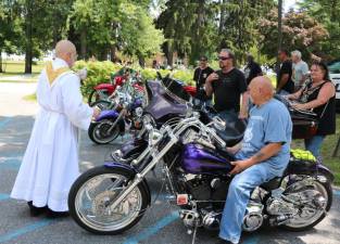 St. Stephen’s Pastor Rev. Jack Arlotta blessed each of the bikes individually.