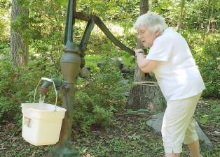 Phyllis Briller, hard at work bringing in another pail of water just like the old days.