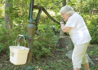 Phyllis Briller, hard at work bringing in another pail of water just like the old days.