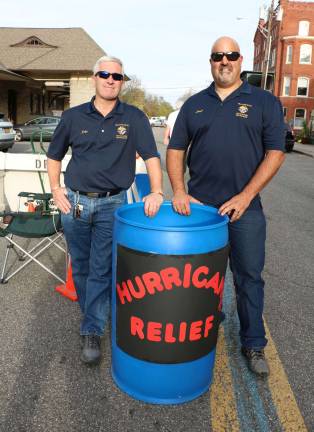 Photo by Roger Gavin John Mac Donald and Lloyd Van Duzer, members of Warwick Council 4952 of the Knights of Columbus, collect funds for disaster relief during a recent concert event on Railroad Green.