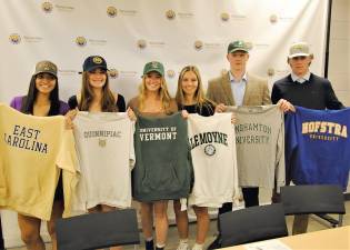 From Left to right: Warwick’s Skyler Blanton (ECU), Paige Girardi (Quinnipiac), Kiera Larney (Vermont), Stephanie Malota (LeMoyne), Jackson Mitchell (Binghamton) and Ryan McLaughlin (Hofstra) show off their new school colors at the Press Conference on Warwick HS Campus November 10.