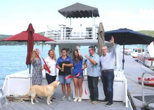 On Wednesday, July 24, members of the Warwick and Greenwood Lake Chambers of Commerce joined owners Rebecca Dykstra (center left) and Charlotte Hillier (center right) to celebrate their new 50-foot double decker pontoon boat yacht with a ribbon cutting by Greenwood Lake Marina owner Elena Dykstra (center).
