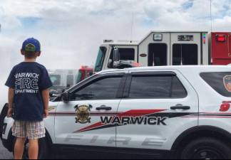 On Saturday, Aug. 17, the Warwick Fire Department attended the wet down of new Chester fire apparatuses at the Chester Commons Park. Future Junior Firefighter Ethan Reilly, the son of Lt. Ryan Reilly, awaits to participate in the water play.