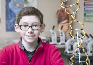 Warwick Valley Middle School seventh grader Evan Grundfast in a science classroom.