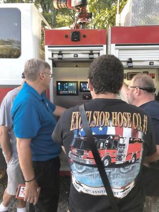 An instructor explains the new SAMS IDEX Pump technology to Acting Captain Ryan Reilly from the Excelsior Hose Company #1 and Past Captain Chris Gardner.