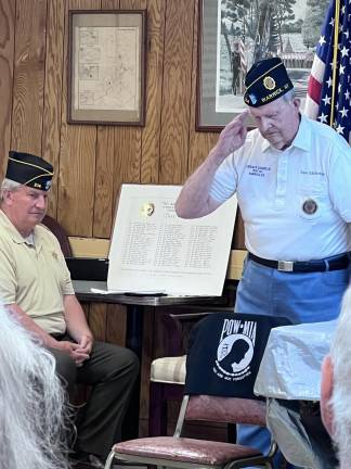 World War II Veteran Don McFarland salutes the POW-MIA Flag during a prior Warwick Flag Day service.