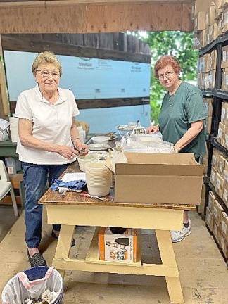 Dot Zwerin (left) and Peg Ross have pieced together thousands of artifacts discovered in a dig behind the Warwick Historical Society’s Shingle House on Forester Ave. in the Village of Warwick.