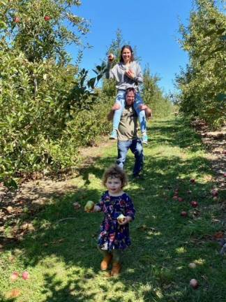 Dr. Sarah Marpet and Dr. Brian Civatte apple picking in Warwick with their daughter.
