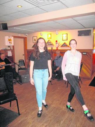 Megan Bushey, left, from Washingtonville, and Saoirse Trazino, from Greenwood Lake, perform Irish dancing as the music plays.