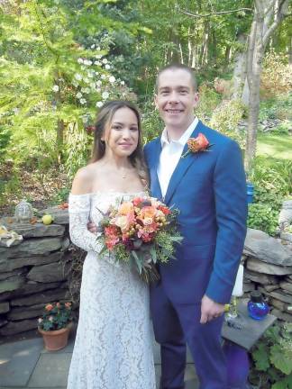 Dr. Mikki Pulju and Ryan Ujazdowski exchanged marriage vows earlier this month at the Warwick home of Frank Petrucci and Heidi Hamilton. Warwick Village Mayor Michael Newhard officiated. The couple live in Mamaroneck. Photo by Ed Bailey.