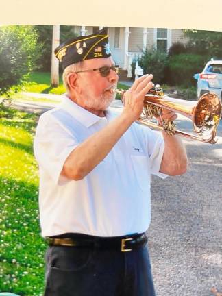 Tony Cosimano, former West Point band member and Vietnam helicopter pilot, played “Taps.”