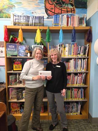 Katherine Callan-Montemaranoof the Greenwood Lake Lions Club presents a $500 donation to Sandy Newman, treasurer of the Greenwood Lake Public Library.